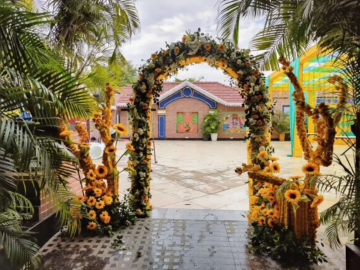 Kalinga Events - Golden arch mandap with vibrant floral decorations, wedding planner Odisha